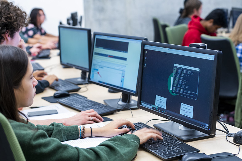 A photo of a student in front of a computer. 