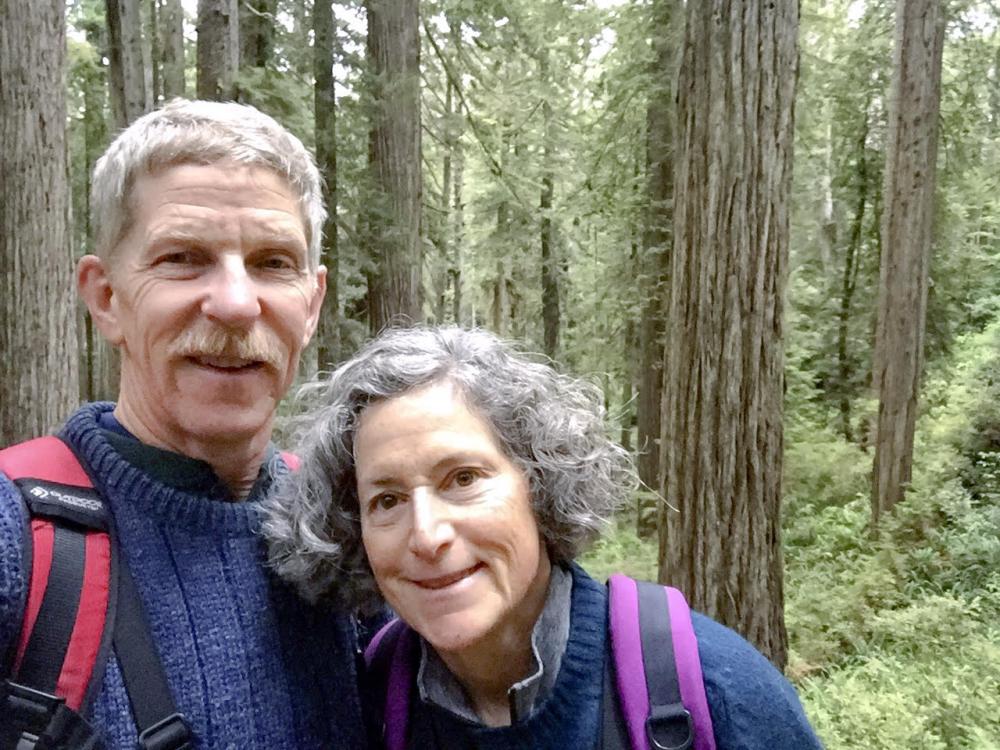 Eric Wier and Laura Frank hiking in the woods.