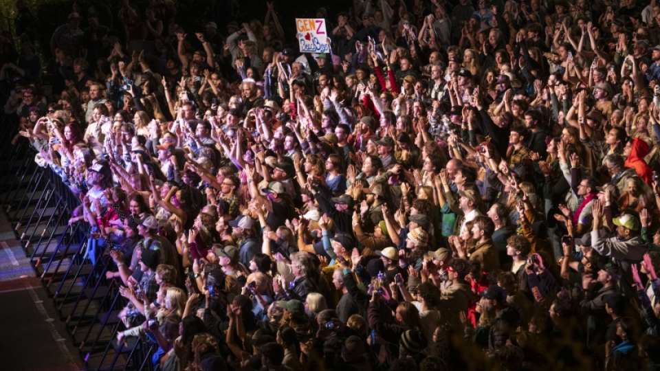 A huge crowd looking toward the stage with hundreds of people.