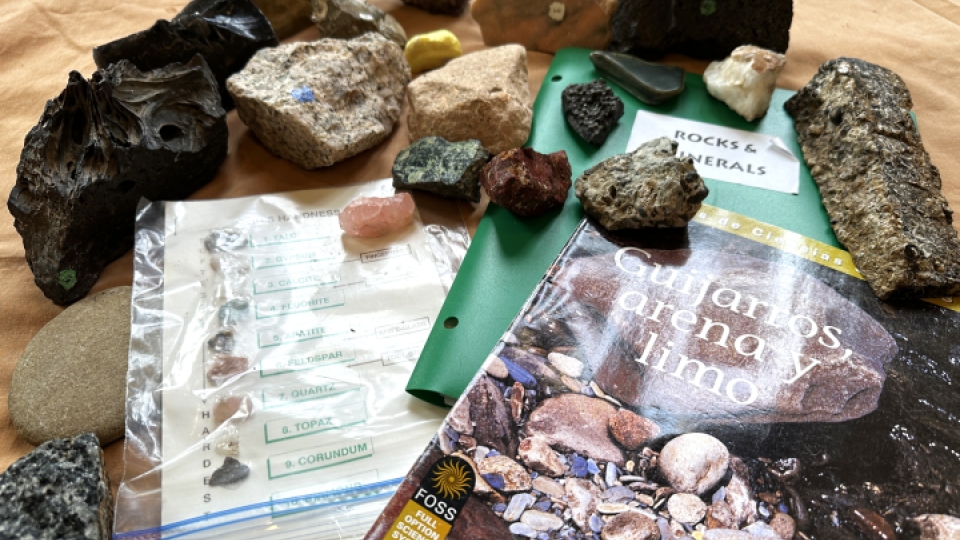 A display of rocks and minerals on top of manuscripts.