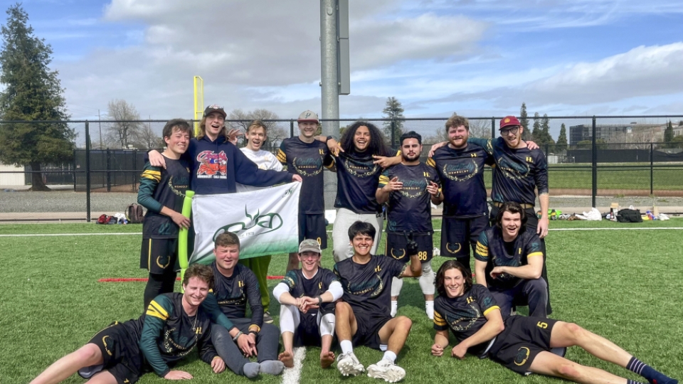 Men's Ultimate Frisbee team photo on the field after a game.