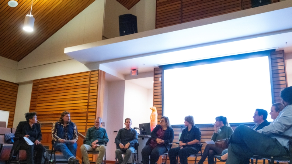 Politics students and faculty discussing topics in a forum.