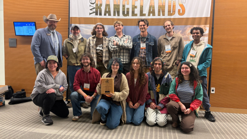 A group photo of 13 students and a teacher in the Soils and Range Club.