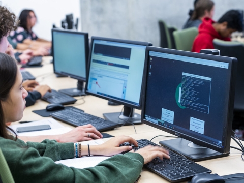 A photo of a student in front of a computer. 