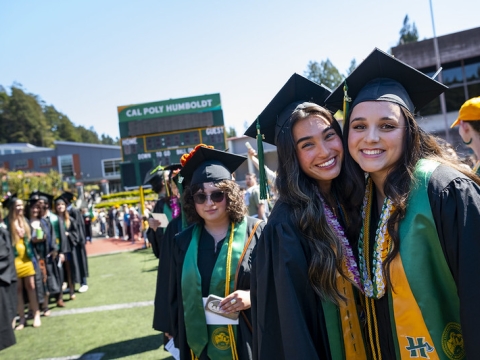 A photo of students at the Cal Poly Humboldt Commencement at the Redwood Bowl.