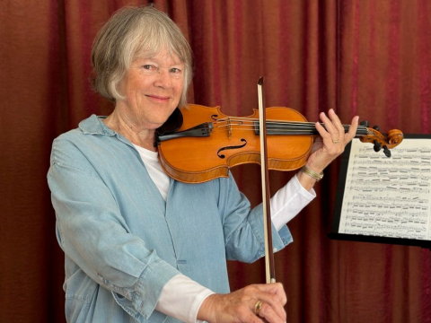 A photo of Julie Fulkerson with a violin