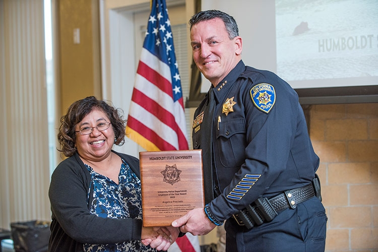 HSU Police Chief Donn Peterson, right, presents an award to lead dispatcher Angelica Preciado.