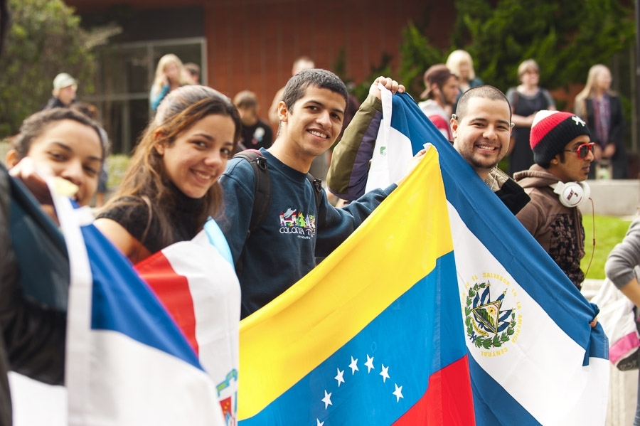 Students holding various international flags