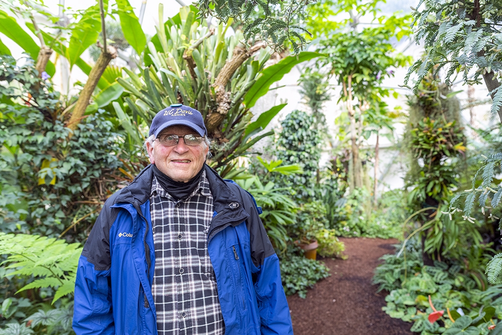 Dennis Walker standing in the greenhouse that's named after him.