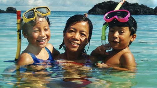 Eden Rubio Furgatch smiles for the camera while snorkeling with her two young kids, Sarah and Nicholas. 