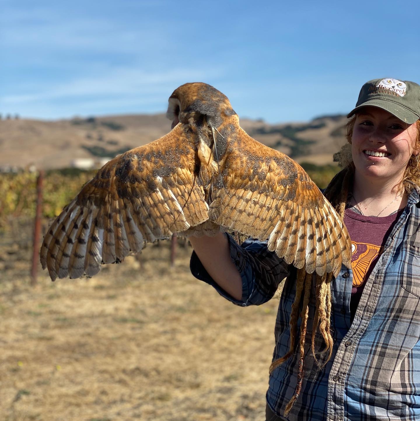 Cal Poly Humboldt Wildlife student holding an owl on their fist.
