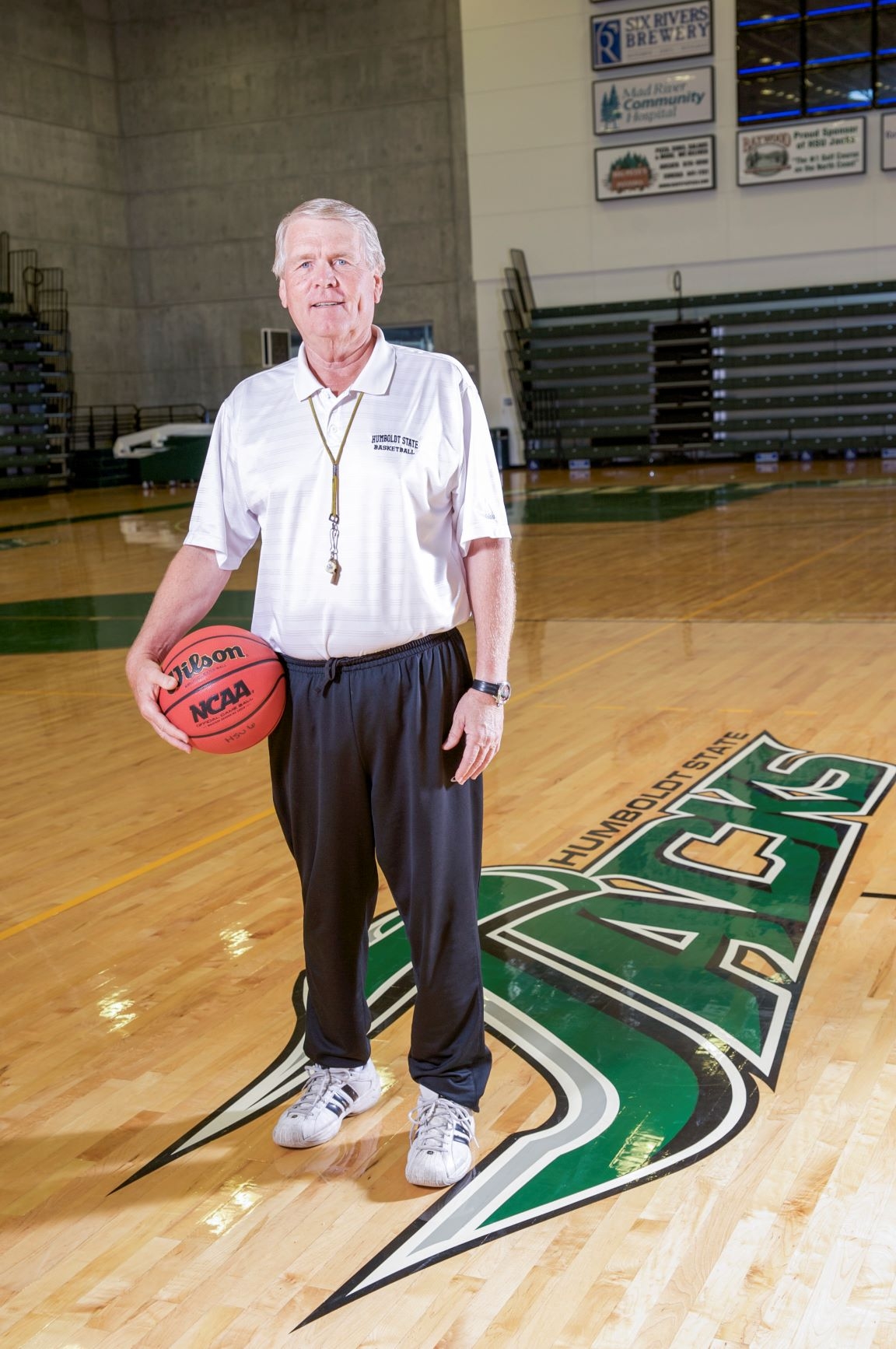 Tom Wood holding a basketball on the court at Cal Poly Humboldt